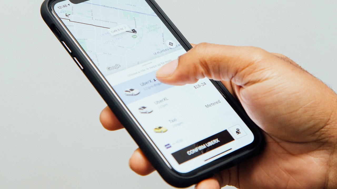 A person using the Uber app to book a ride.
